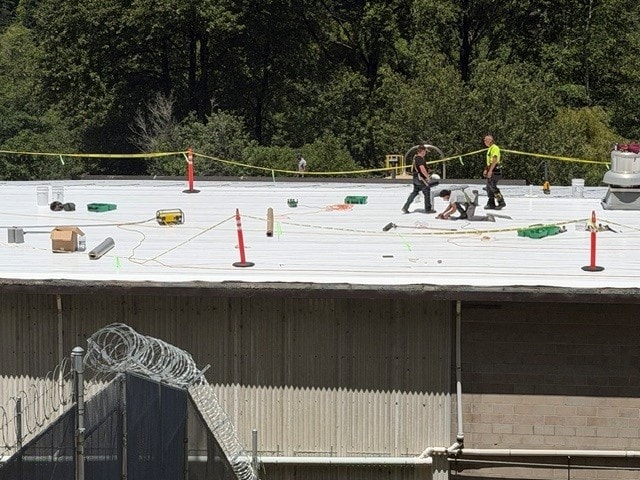 Commercial roofing crew at work — wide view